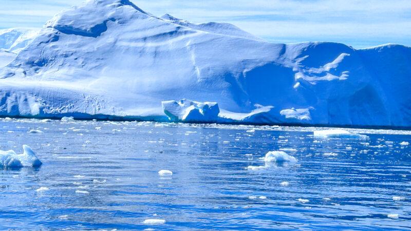 Breathtaking view of Antarctica's pristine snow-covered landscape with towering icebergs.